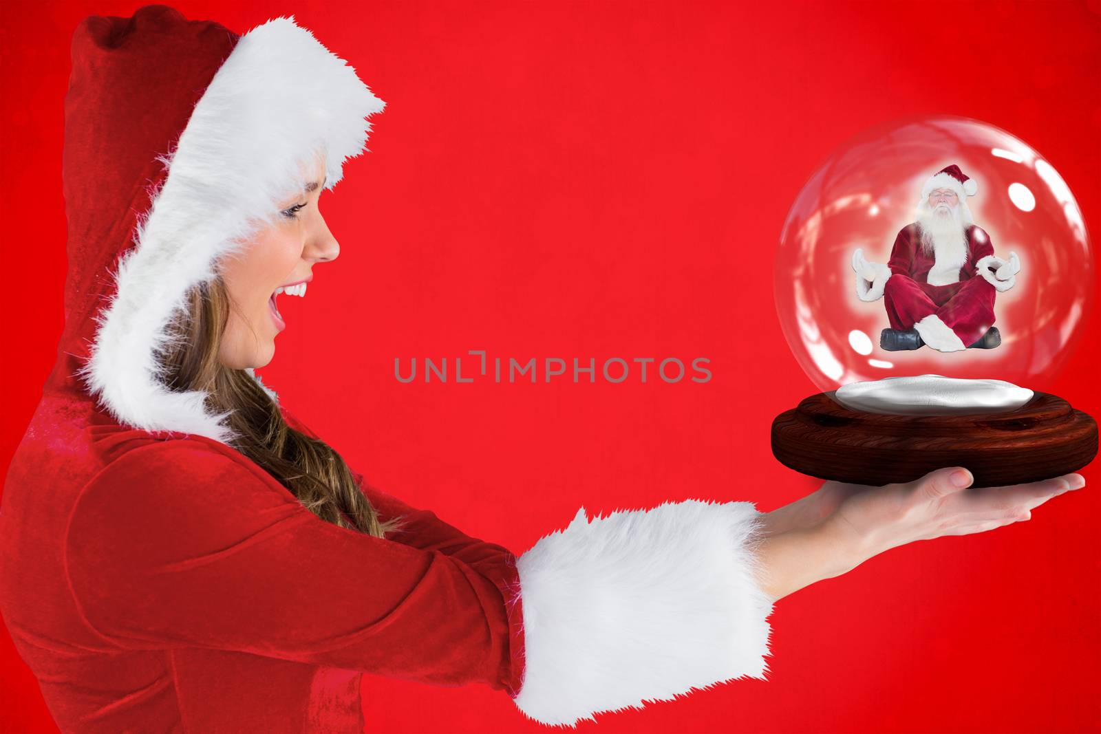 Composite image of sexy santa girl holding snow globe by Wavebreakmedia