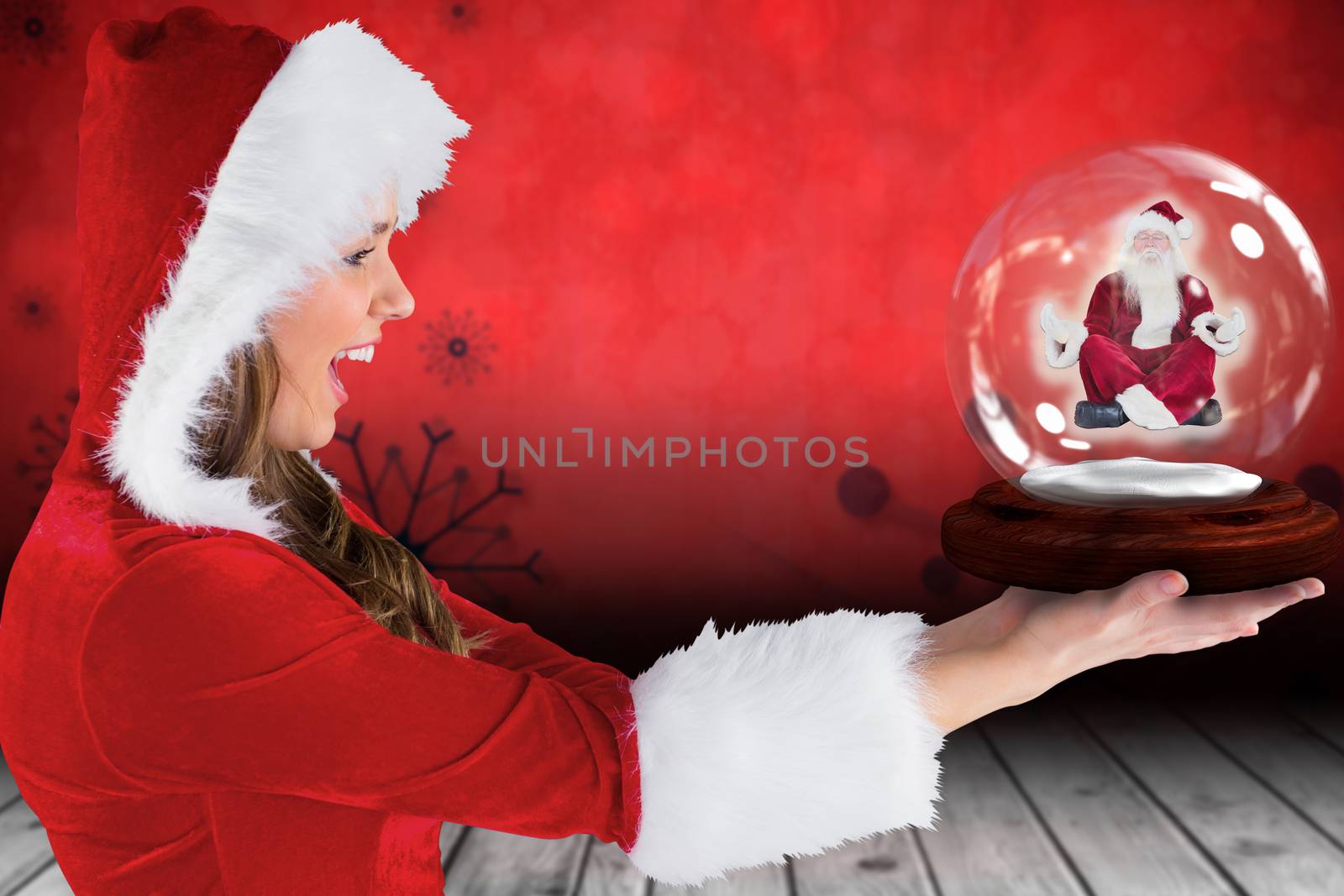 Composite image of sexy santa girl holding snow globe by Wavebreakmedia