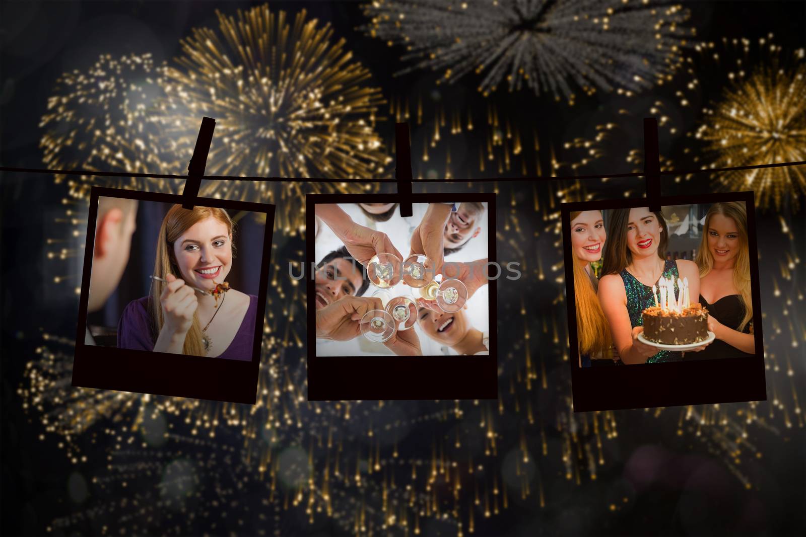 Happy friends celebrating brithday one holding birthday cake against colourful fireworks exploding on black background