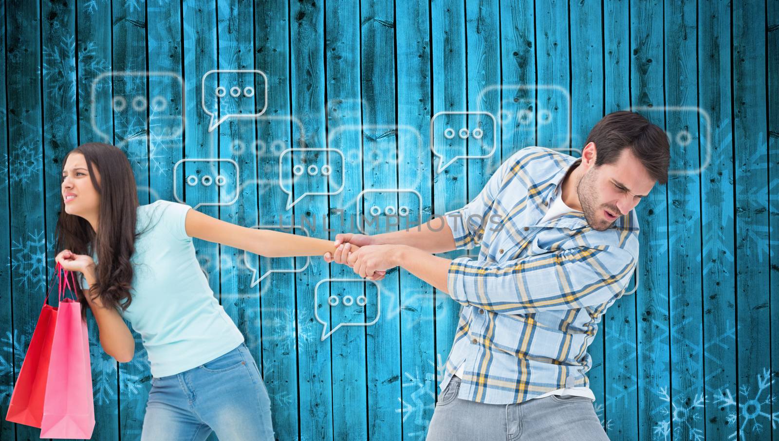 Happy couple with shopping bags against snowflake pattern on blue planks