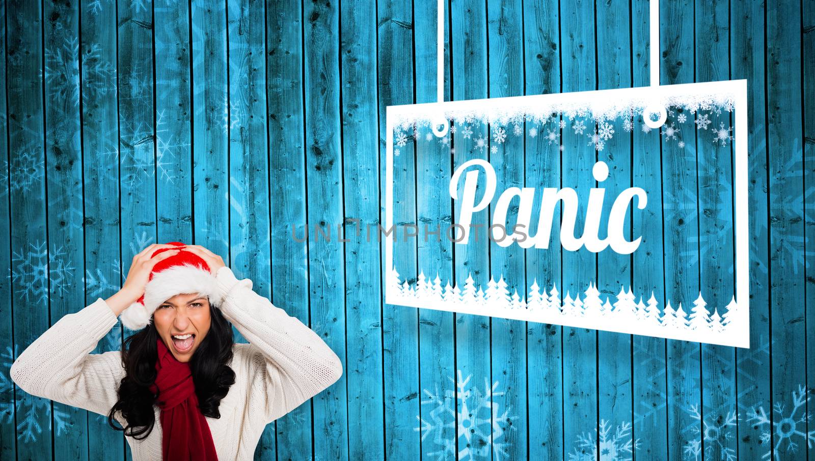Irritated woman looking at camera against snowflake pattern on blue planks