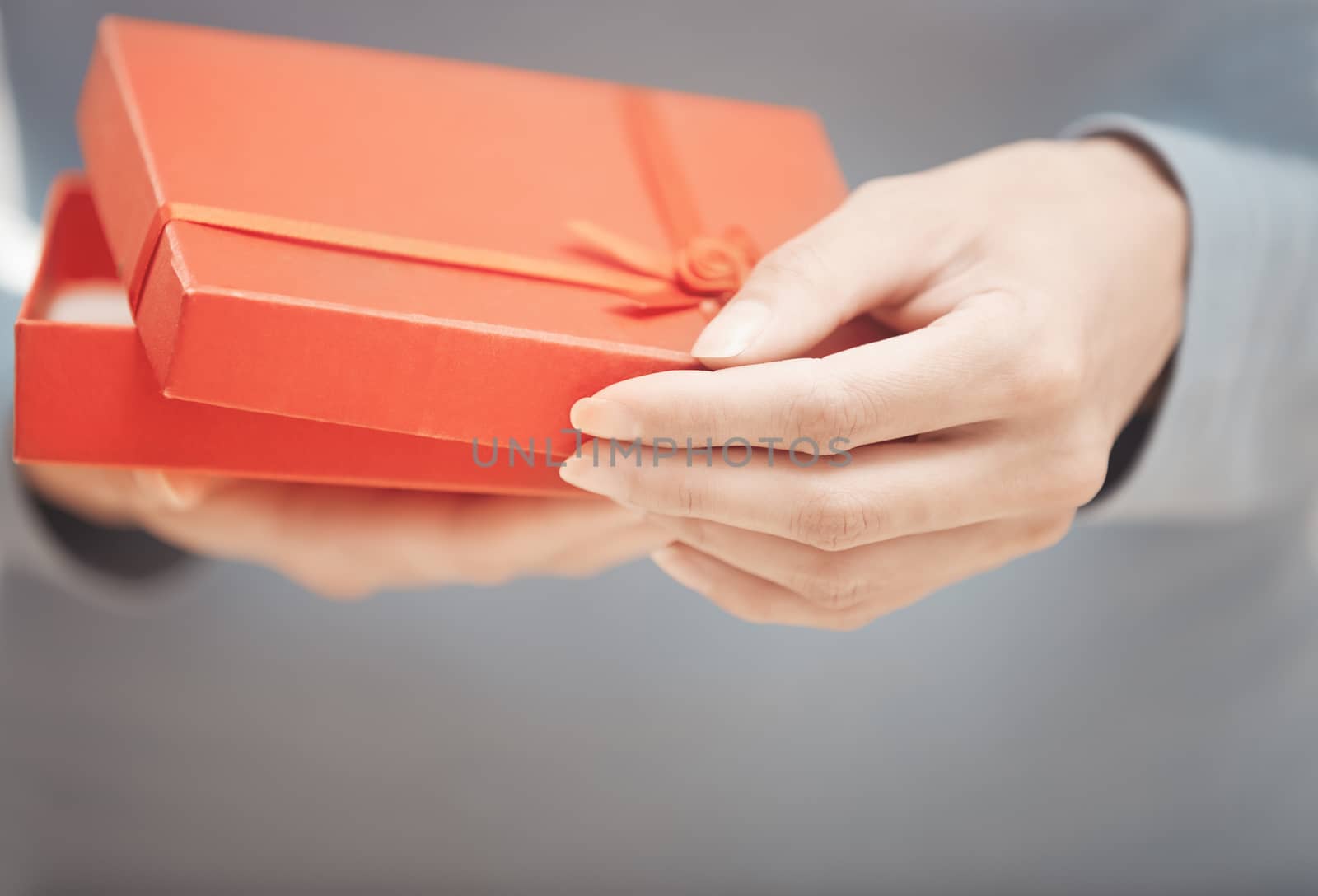Hands of woman with gift box. Close-up photo
