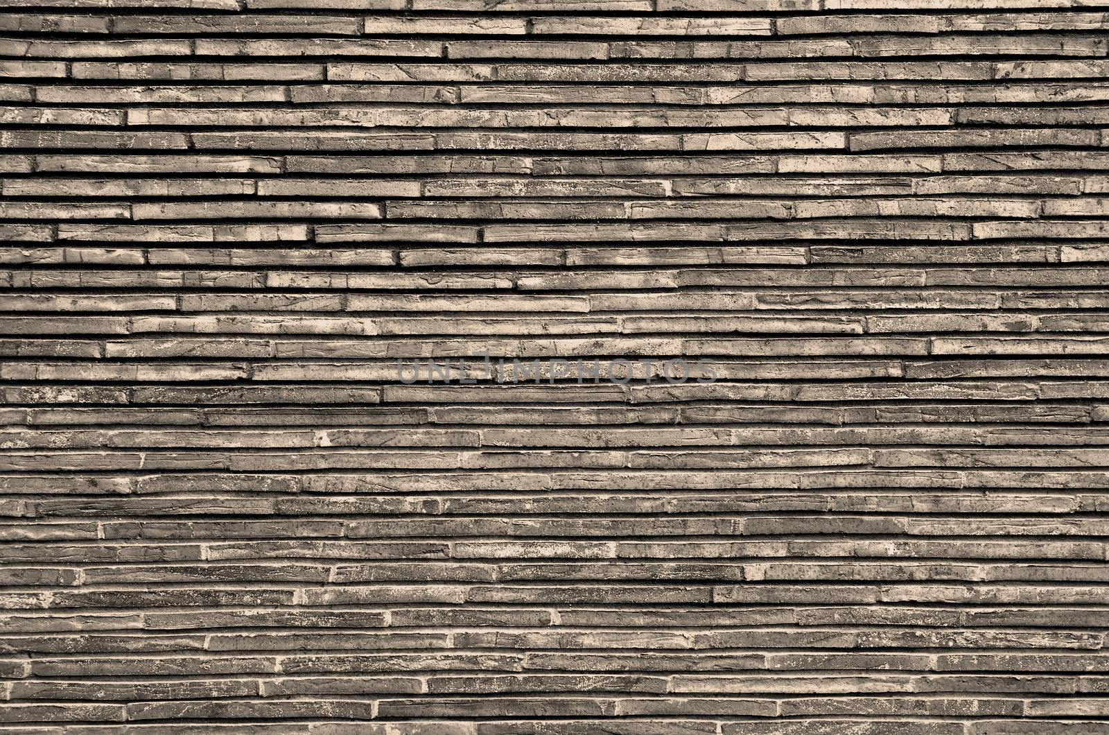 Background of Grey and Sand Colored Plank Stone Exterior Wall closeup