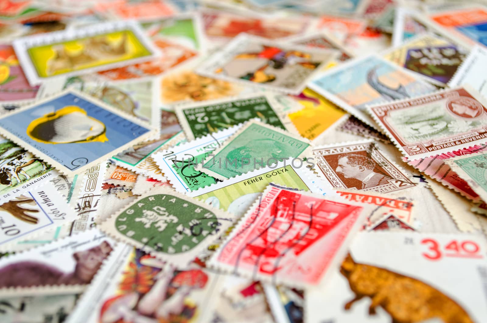 Backdrop of old worldwide postage stamps .
