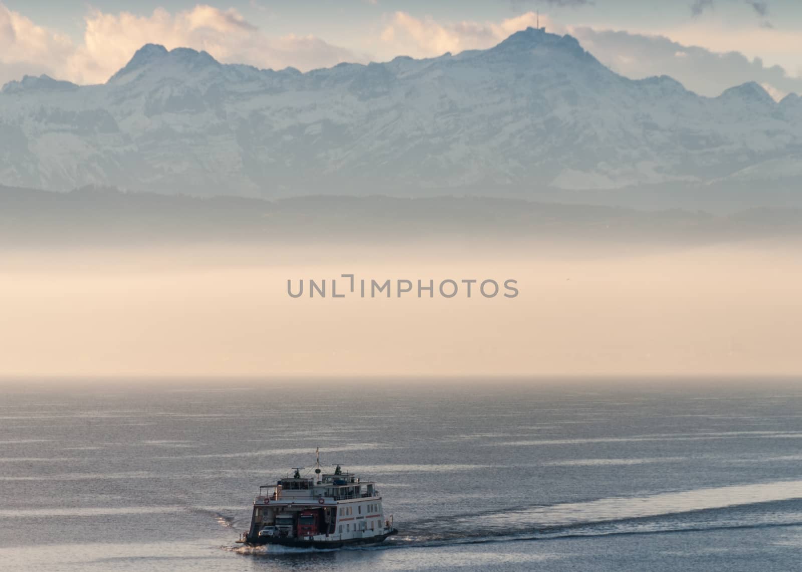 Ferry boat on a mountain lake with fog.