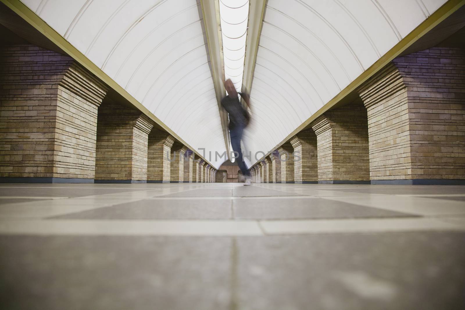 Blurred man on subway platform by sarymsakov