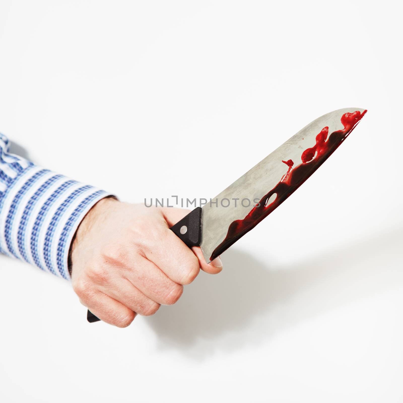 The hand  is holding the knife with blood on a white background.