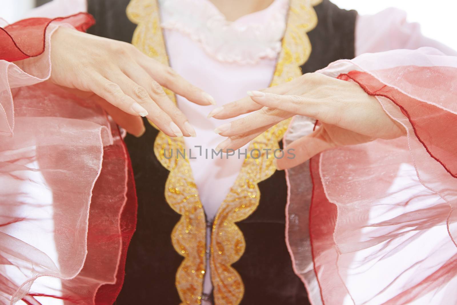 Woman in Oriental national costume dancing. Close-up view