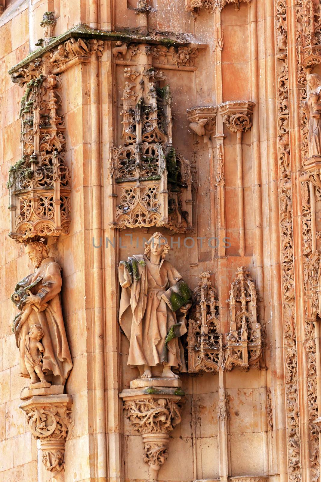 Stone Statues Doorway New Salamanca Cathedral Spain.  The New and Old Cathedrals in Salamanca are right next to each other.  New Cathedral was built from 1513 to 1733 and commissioned by Ferdinand V of Castile, Spain. 