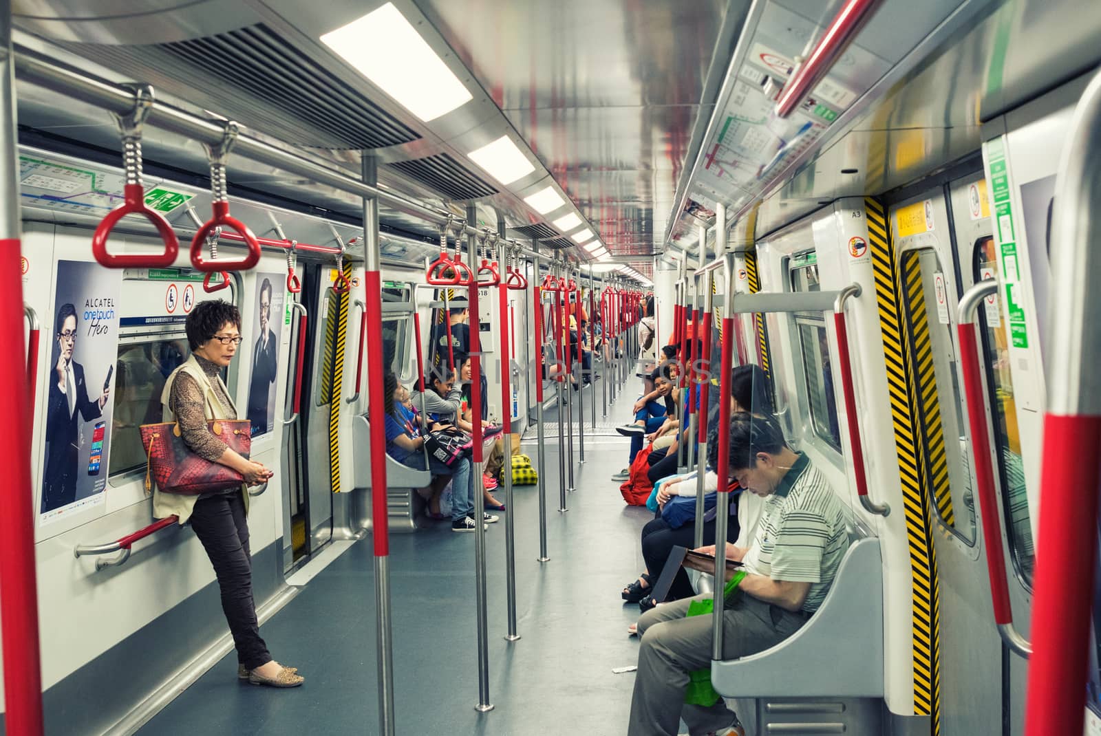HONG KONG - APRIL 22, 2014: Riders on the MTR in Hong Kong, China. In 2012 the MTR reportedly had 46.4% of the public transport market, making it the most popular transport in Hong Kong