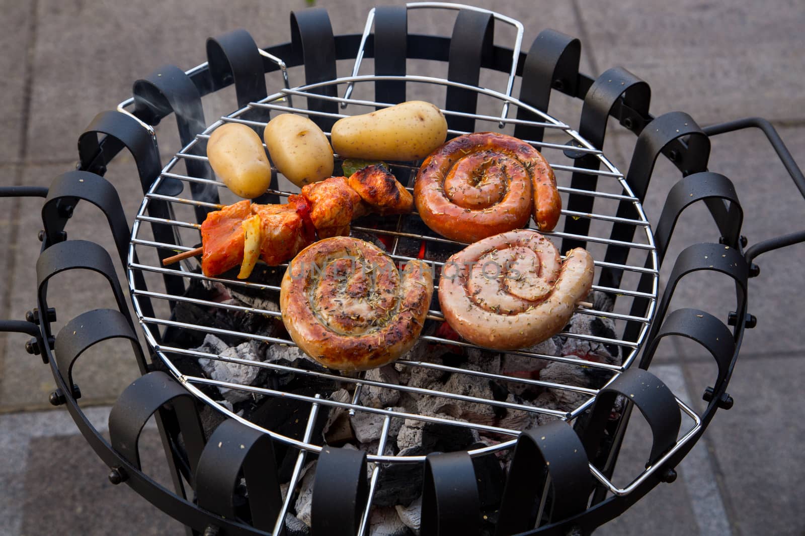 Cooking tastetful meat on a barbecue outside during winter