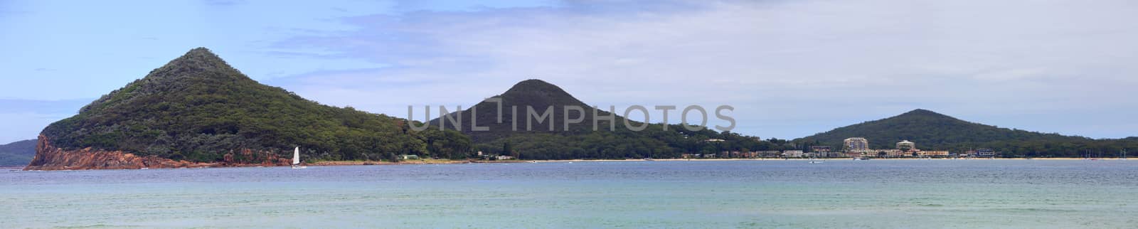 Mt Tomaree, Stephens Peak, Quarry Hill at Port Stephens behind Shoal Bay from across the waters.  Some of the old gun emplacements can be seen when Tomaree was used as a fort and you can only just see one of the lookouts at the summit.