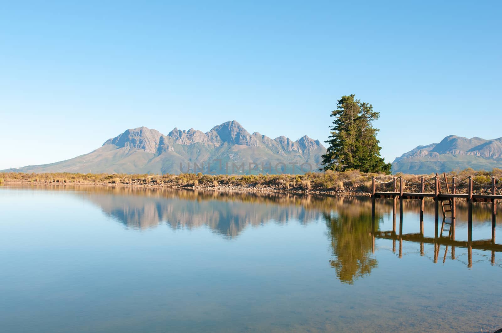 Dam with jetty near Somerset West in the Western Cape Province of South Africa with the Helderberg in the background
