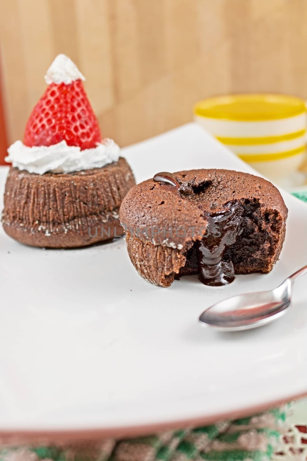 chocolate cake with soft heart and chocolate cake with hat of Santa Claus with spoon