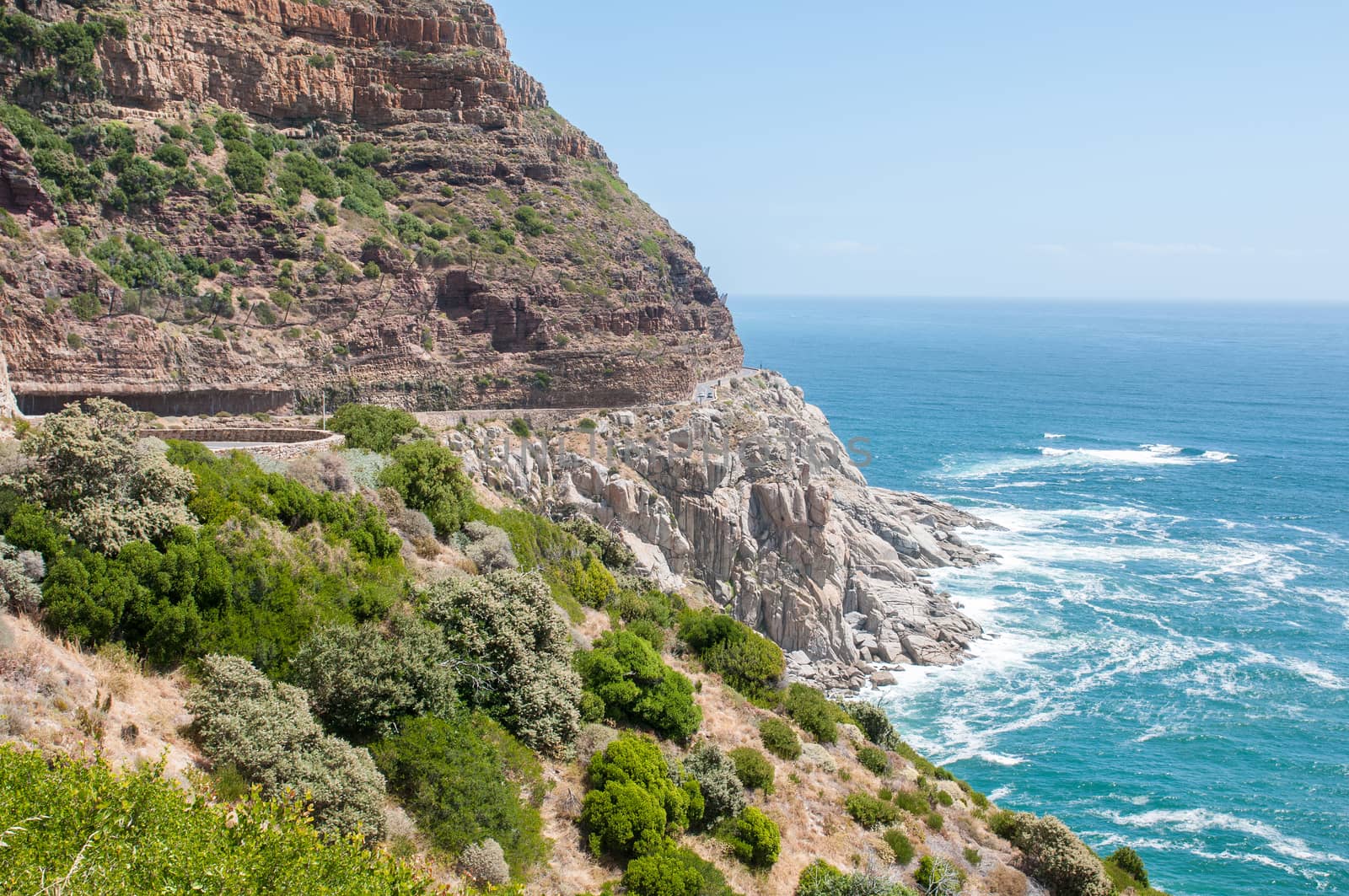 View of Chapmans Peak drive in the Table Mountain National Park in Cape Town, South Africa. Safety nets to keep rockfalls away fron the road are visible
