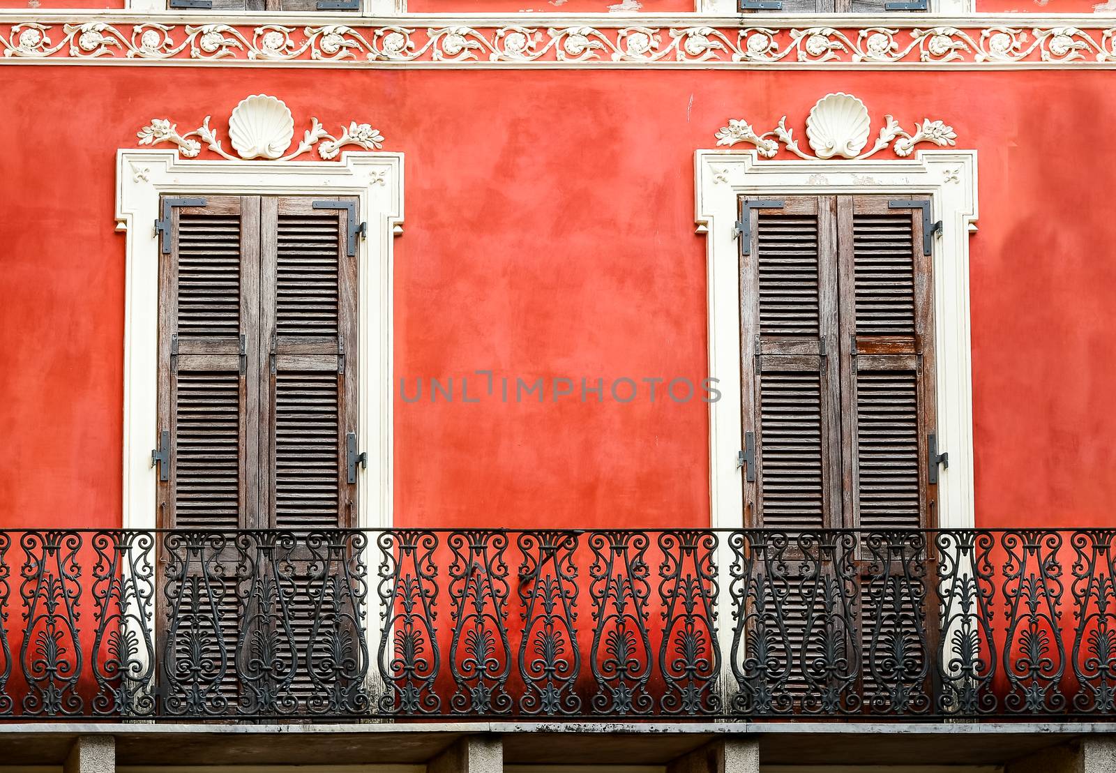 Colorful Italian balcony with doors in vintage style, Sardinia, Italy