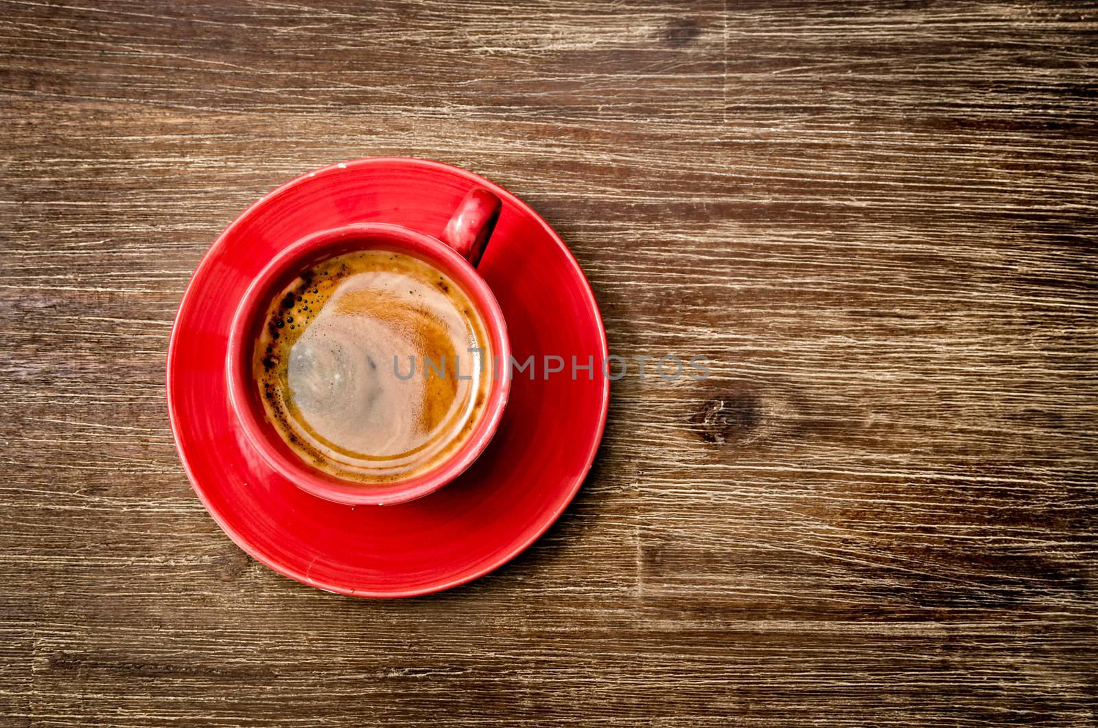 View of coffee in red cup on wooden vintage table by martinm303