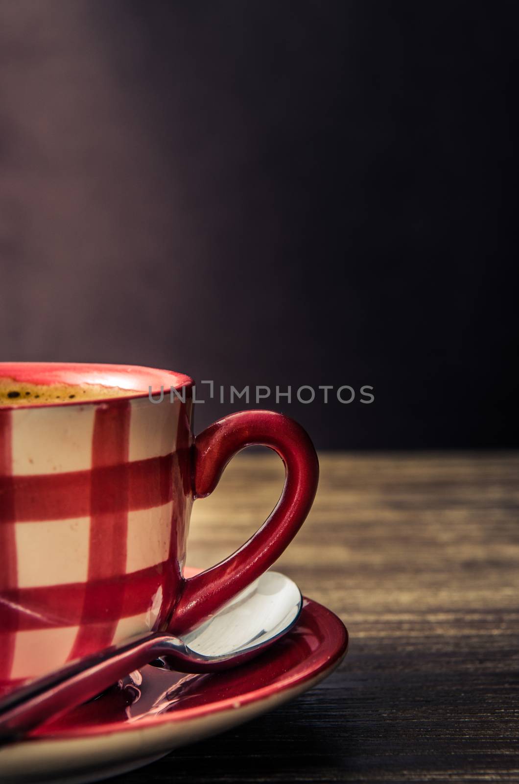 Vintage style detail of coffee cup on wooden table by martinm303