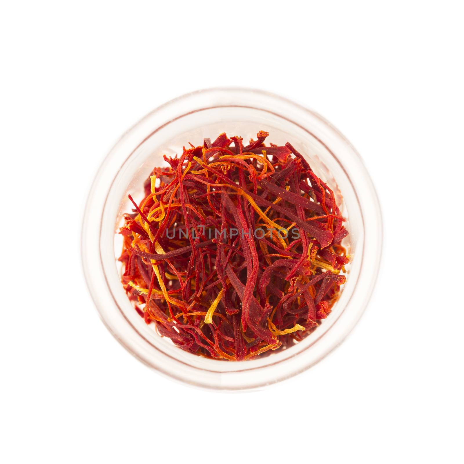 Saffron in glass container from above and isolated on white