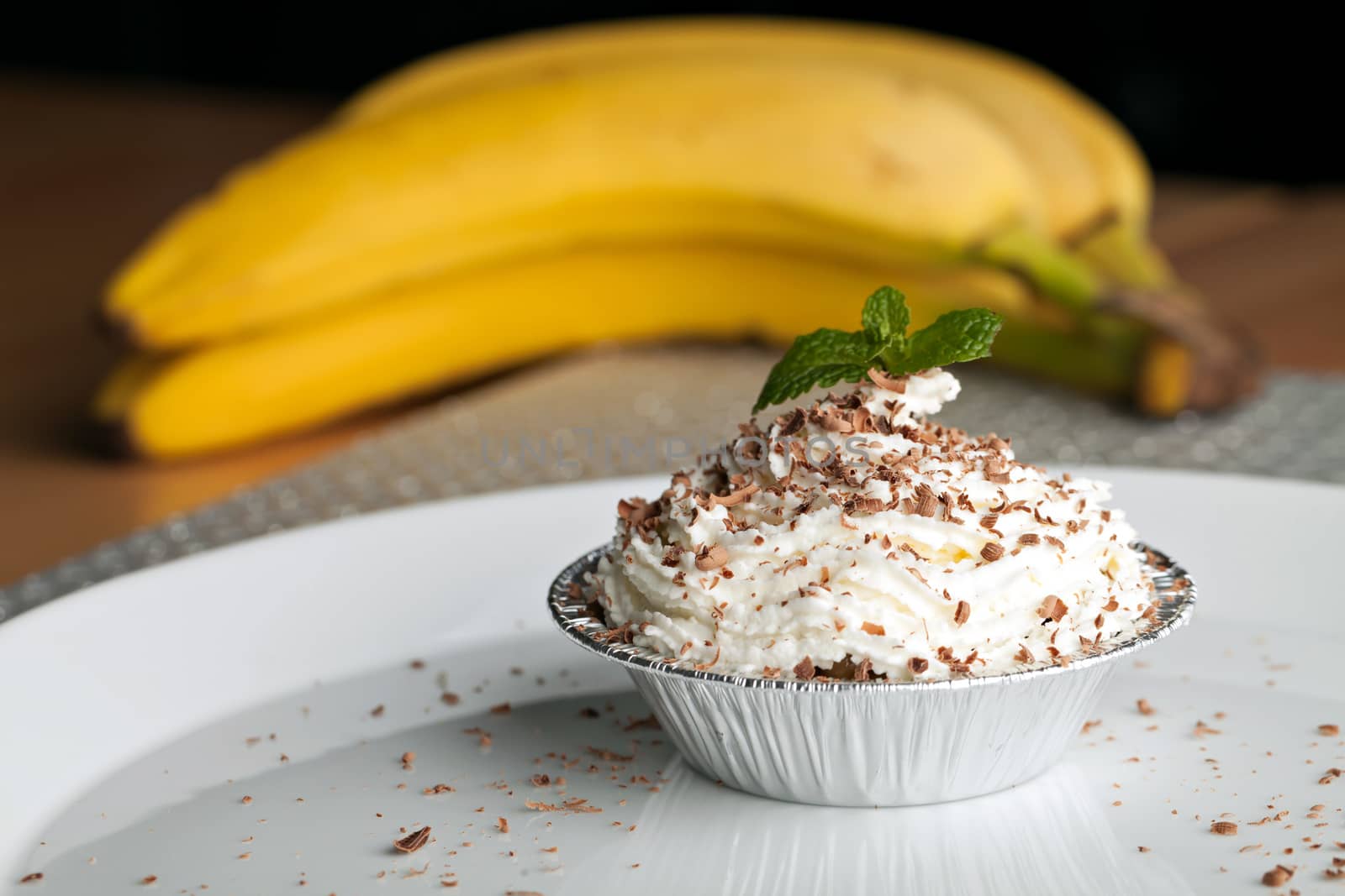 Banana cream dessert with fresh whipped cream and chocolate shavings. Shallow depth of field.