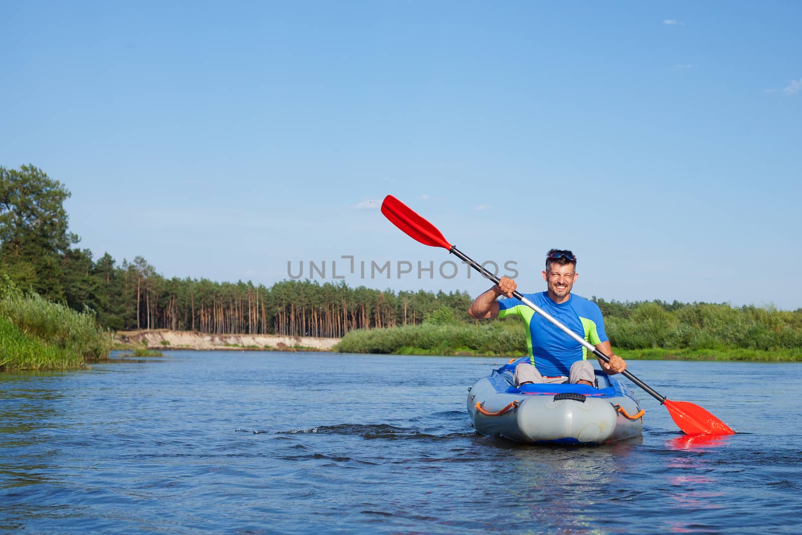 Summer vacation - Young man kayaking on the river