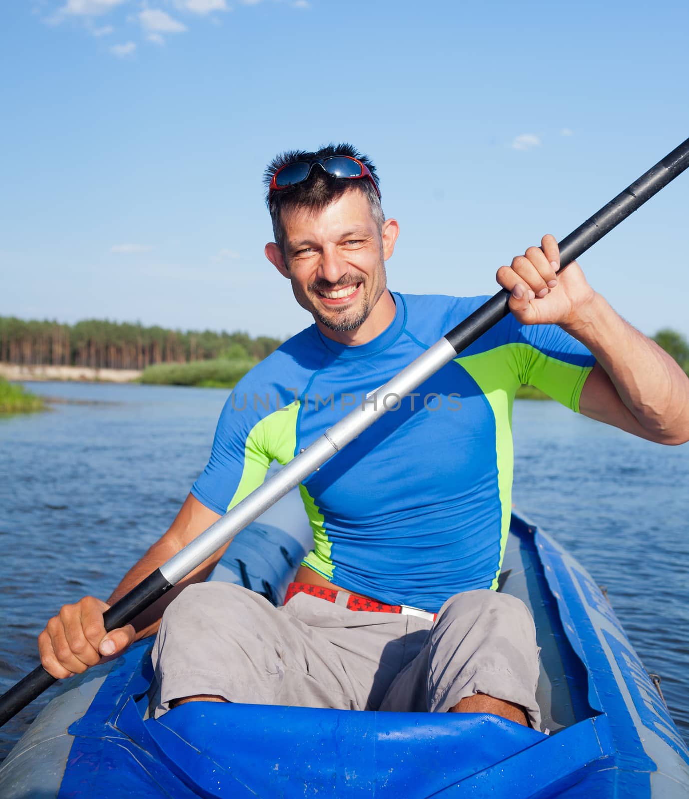 Summer vacation - Young man kayaking on the river