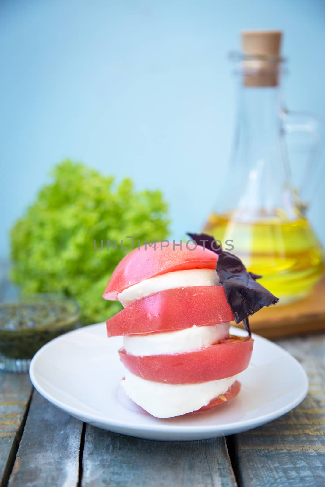 salad with mozzarella,tomatoes,dark basil on wooden retro background