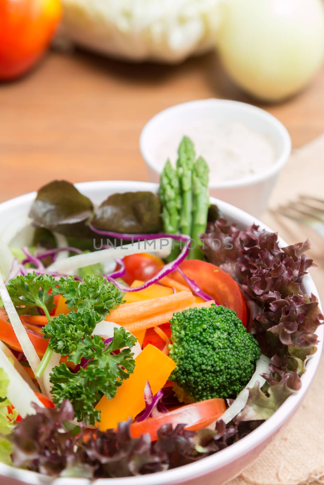 fresh vegetable salad on wood background