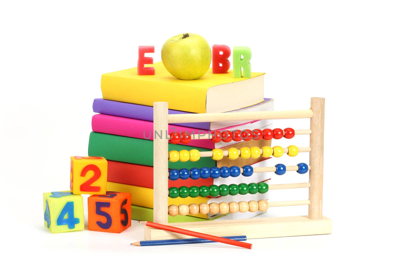 stack of books, apple and abacus over white