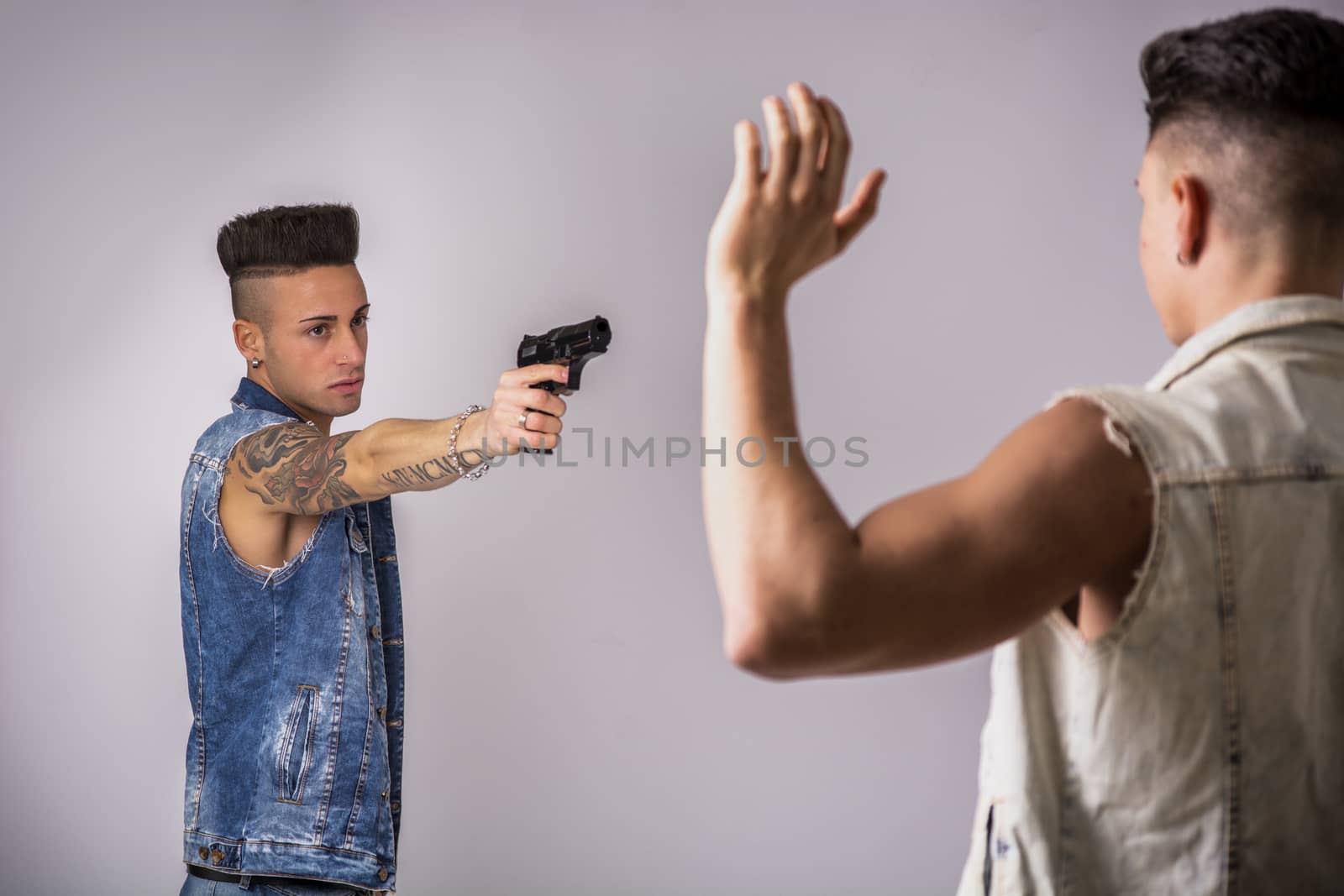 Young Man Pointing a Gun to Another Guy by artofphoto