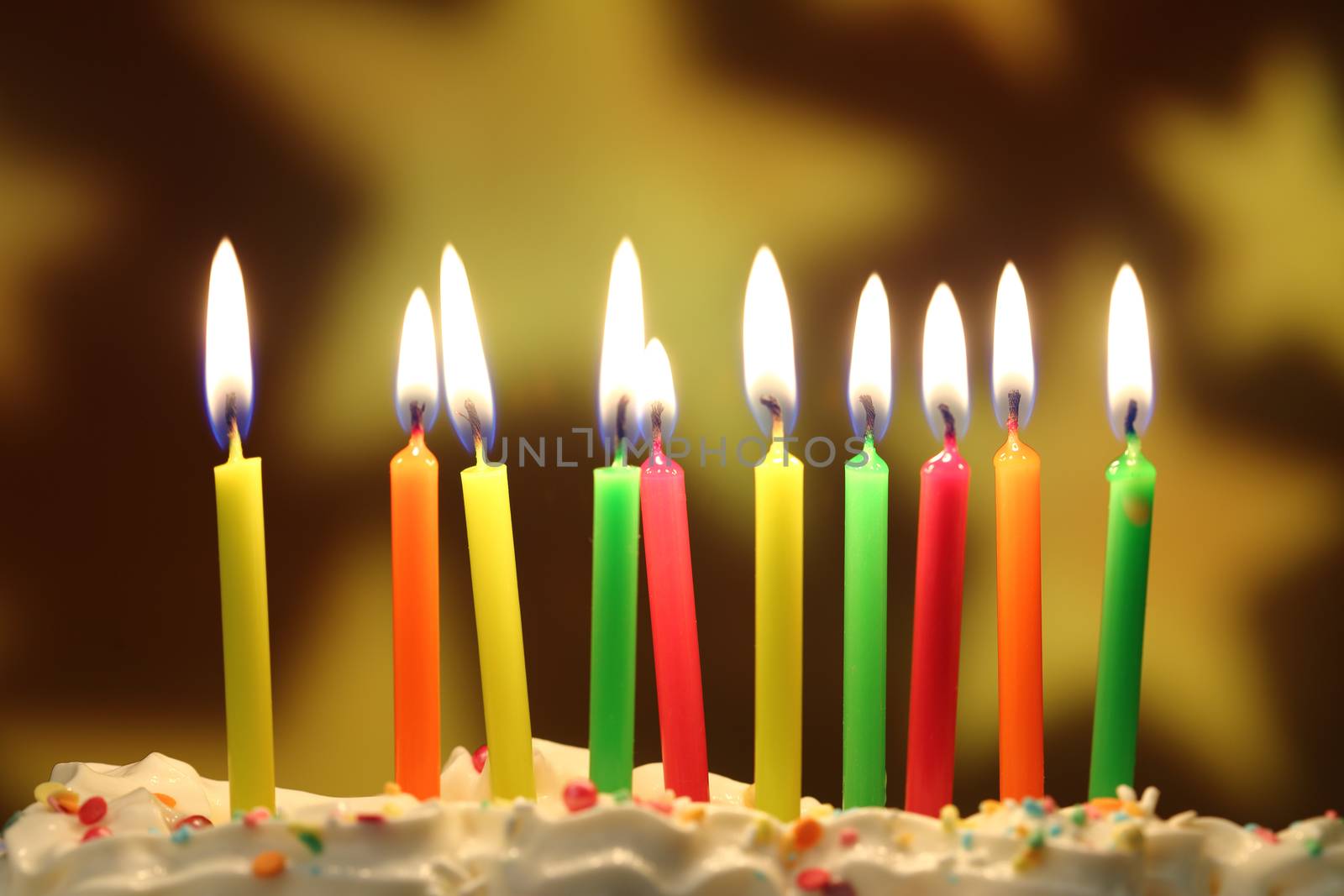 Ten lit birthday candles close up, shallow dof