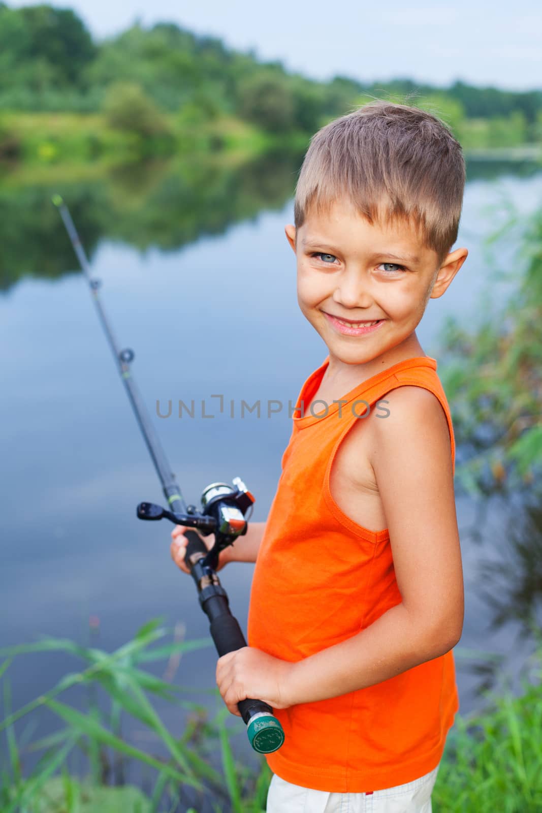 Summer vacation - Photo of little boy fishing on the river.