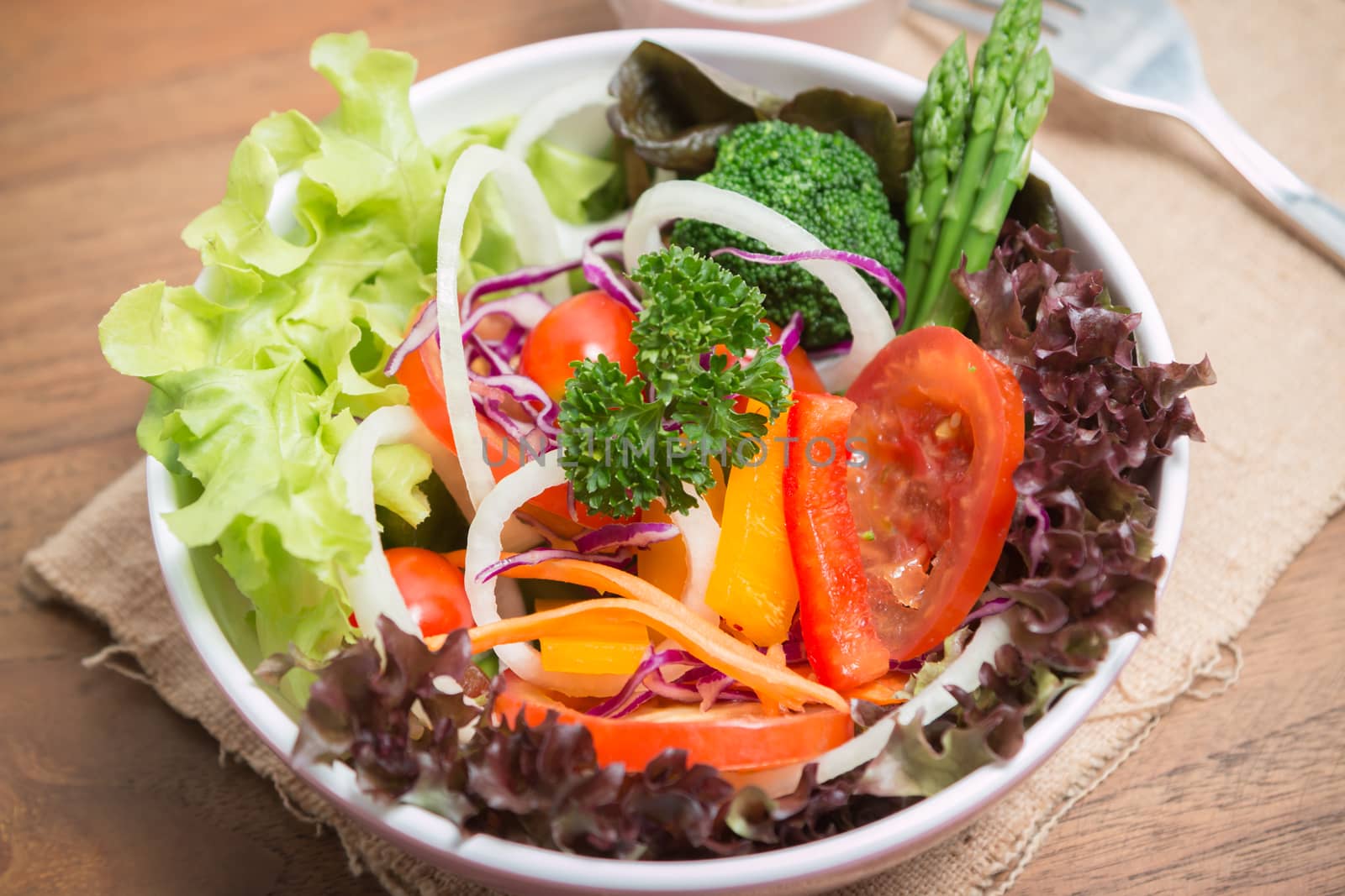 fresh vegetable salad on wood background