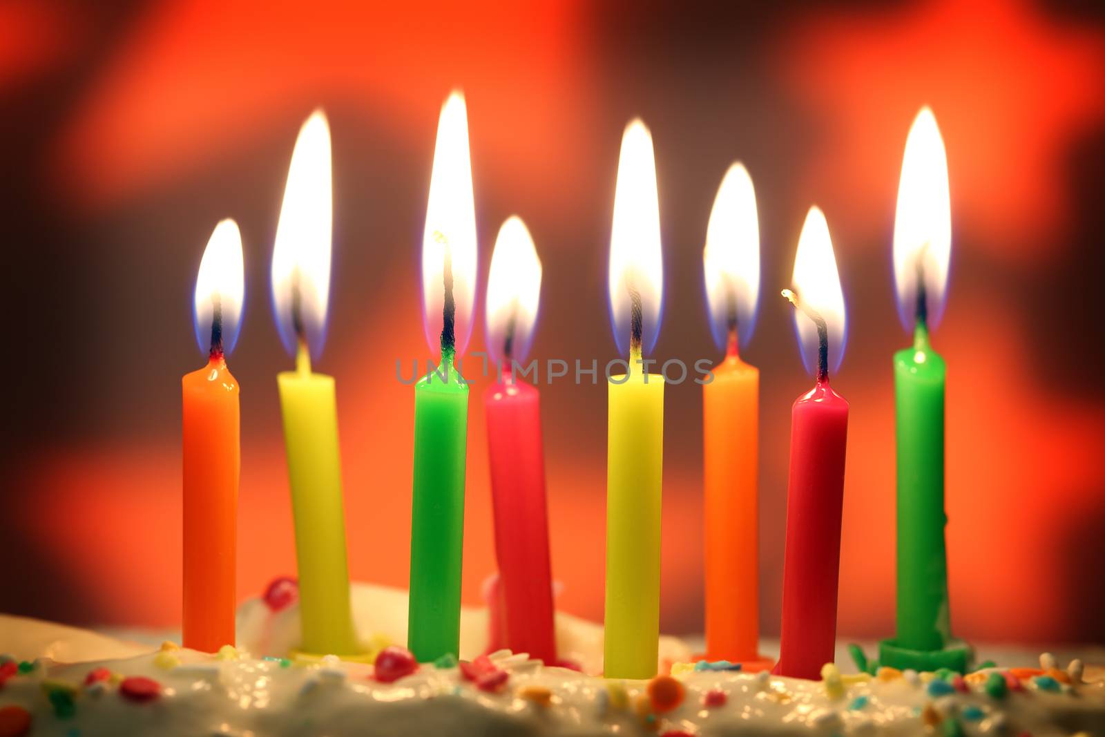 eight lit birthday candles close up, shallow dof