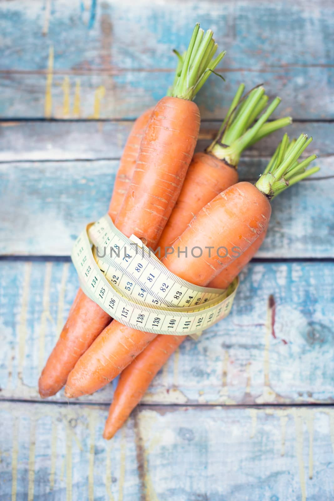 stack of fresh, to the ripe carrot on a wooden background