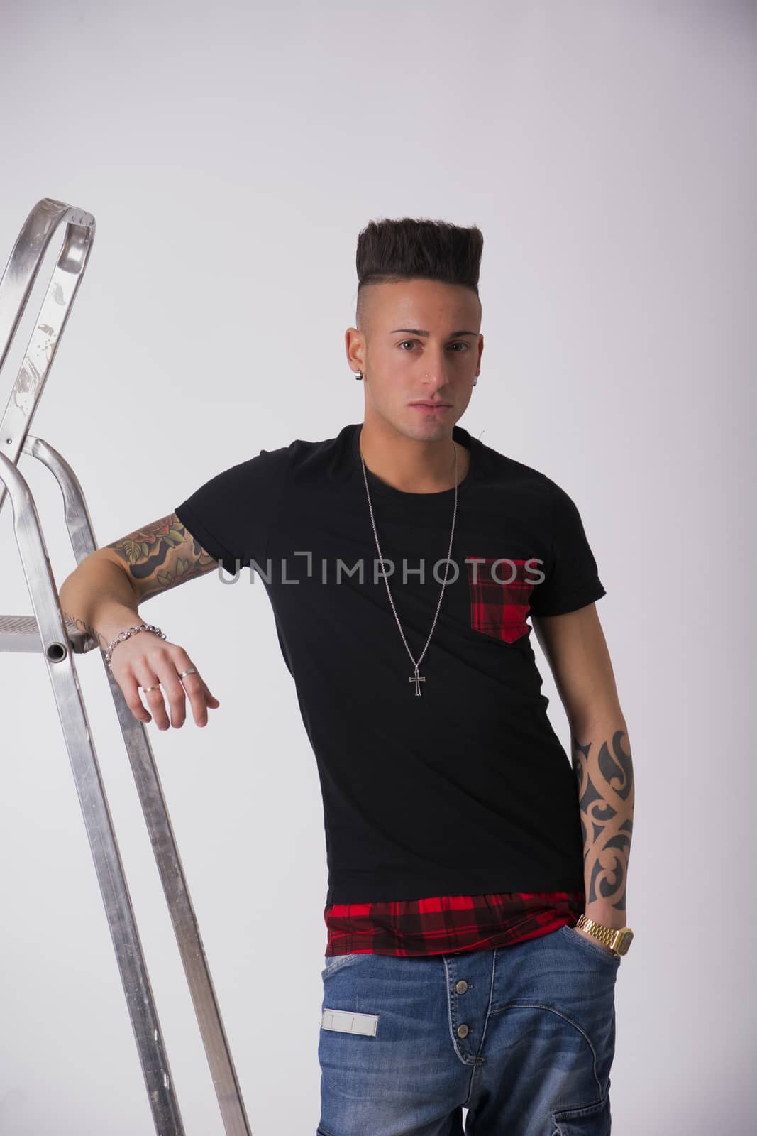 Attractive young man leaning on metal ladder by artofphoto