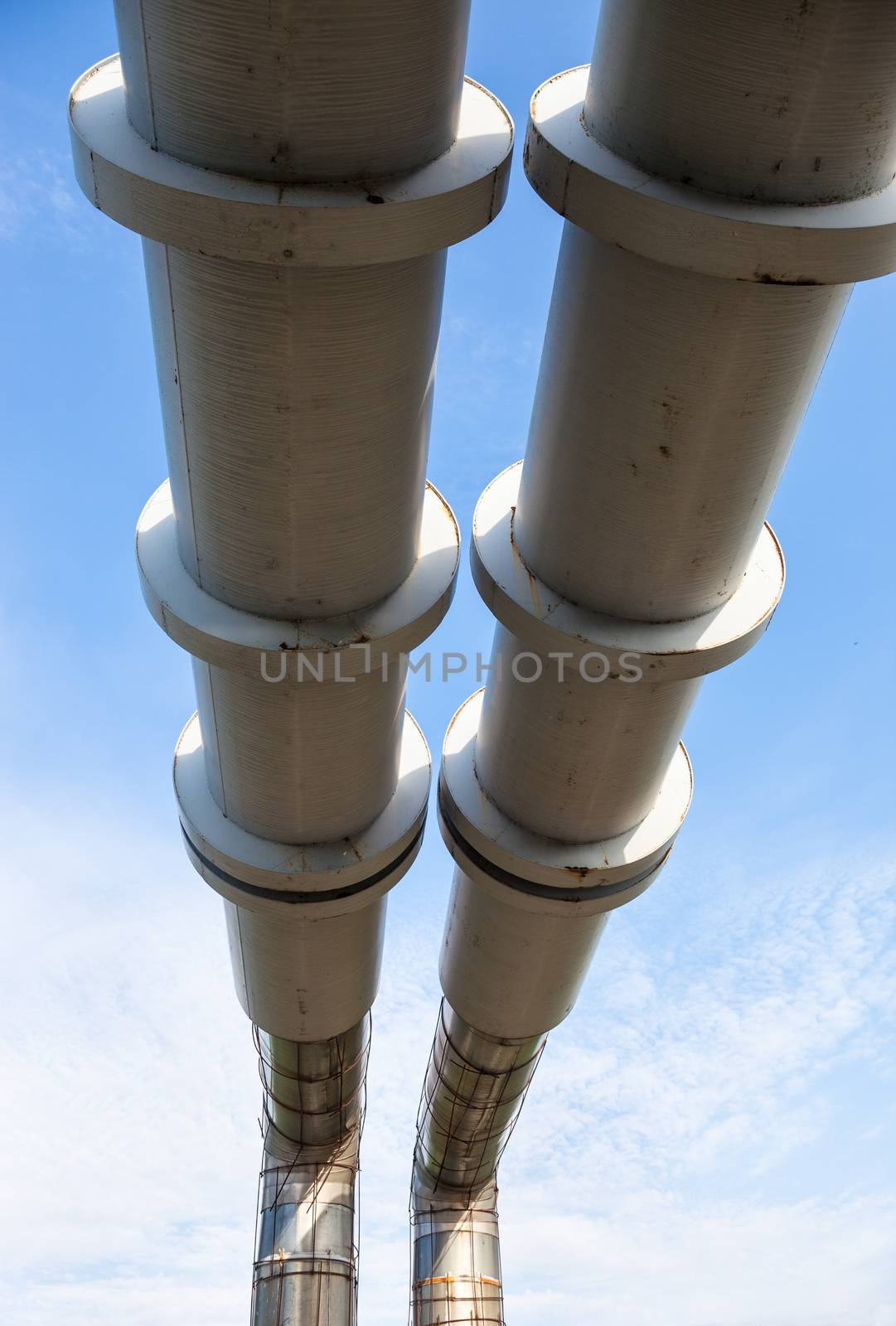 Elevated section of the pipelines against the blue sky