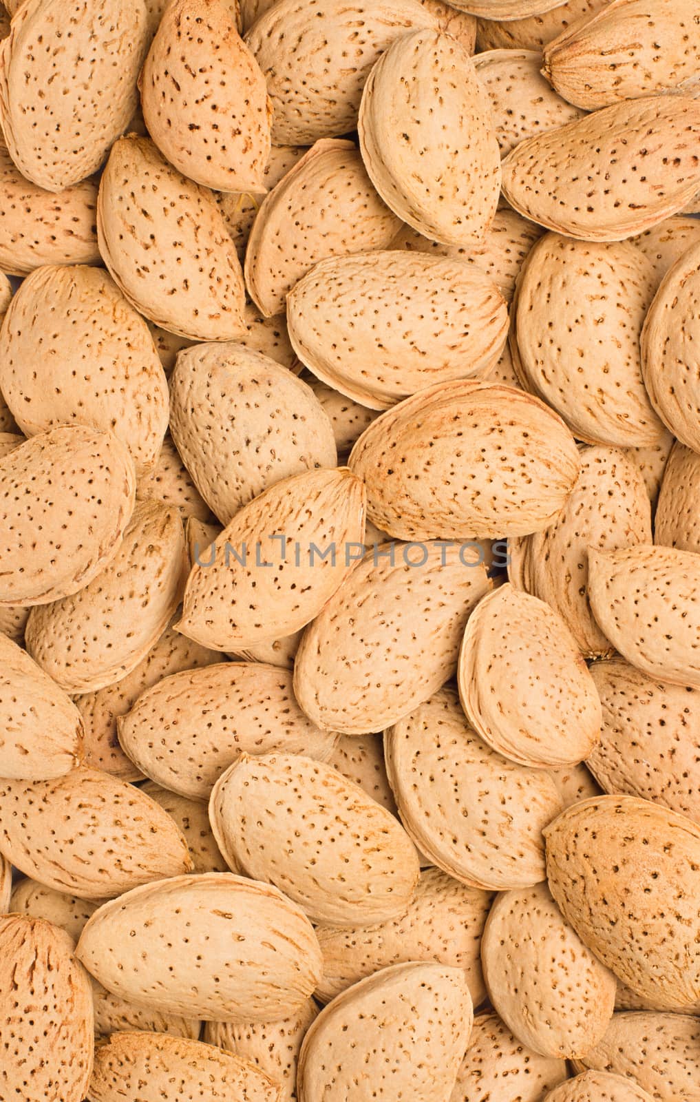 Pile of almonds close-up as background.