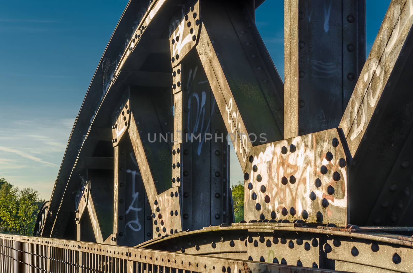 Riveted old arch of an old railway bridge.