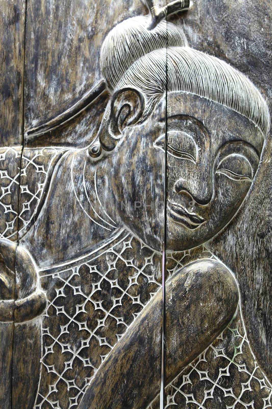 Face of the ancient wood Buddha close up