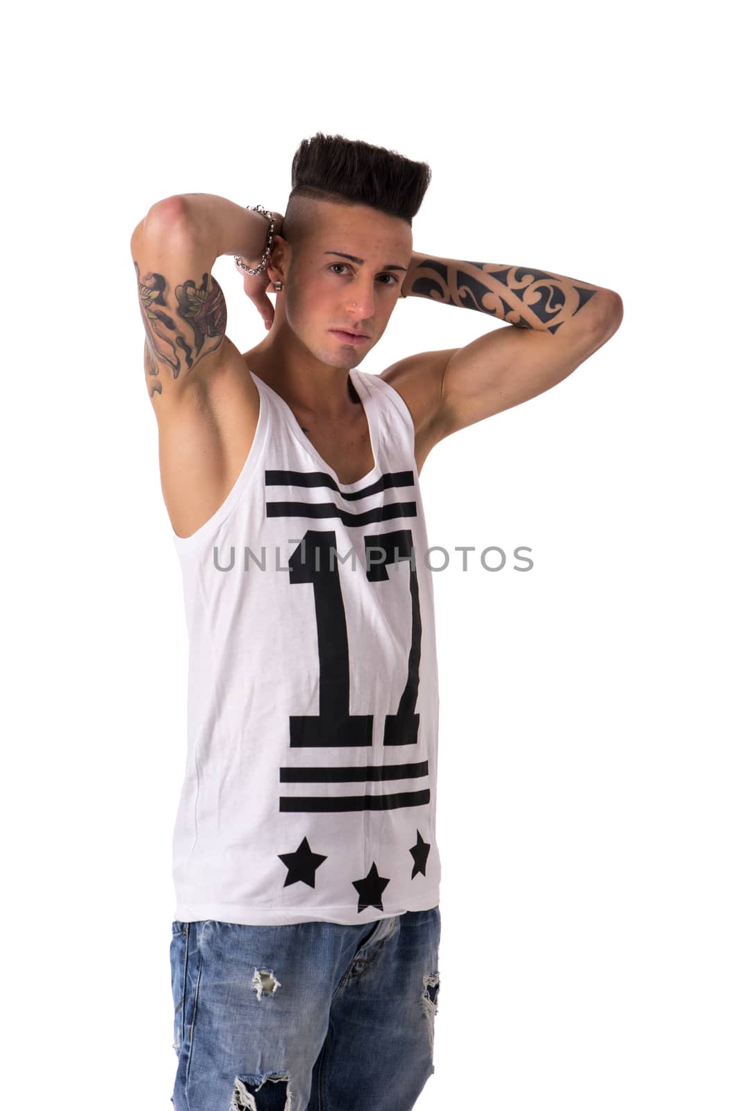 Hip trendy young man with tank top, with hands behind head, isolated on white