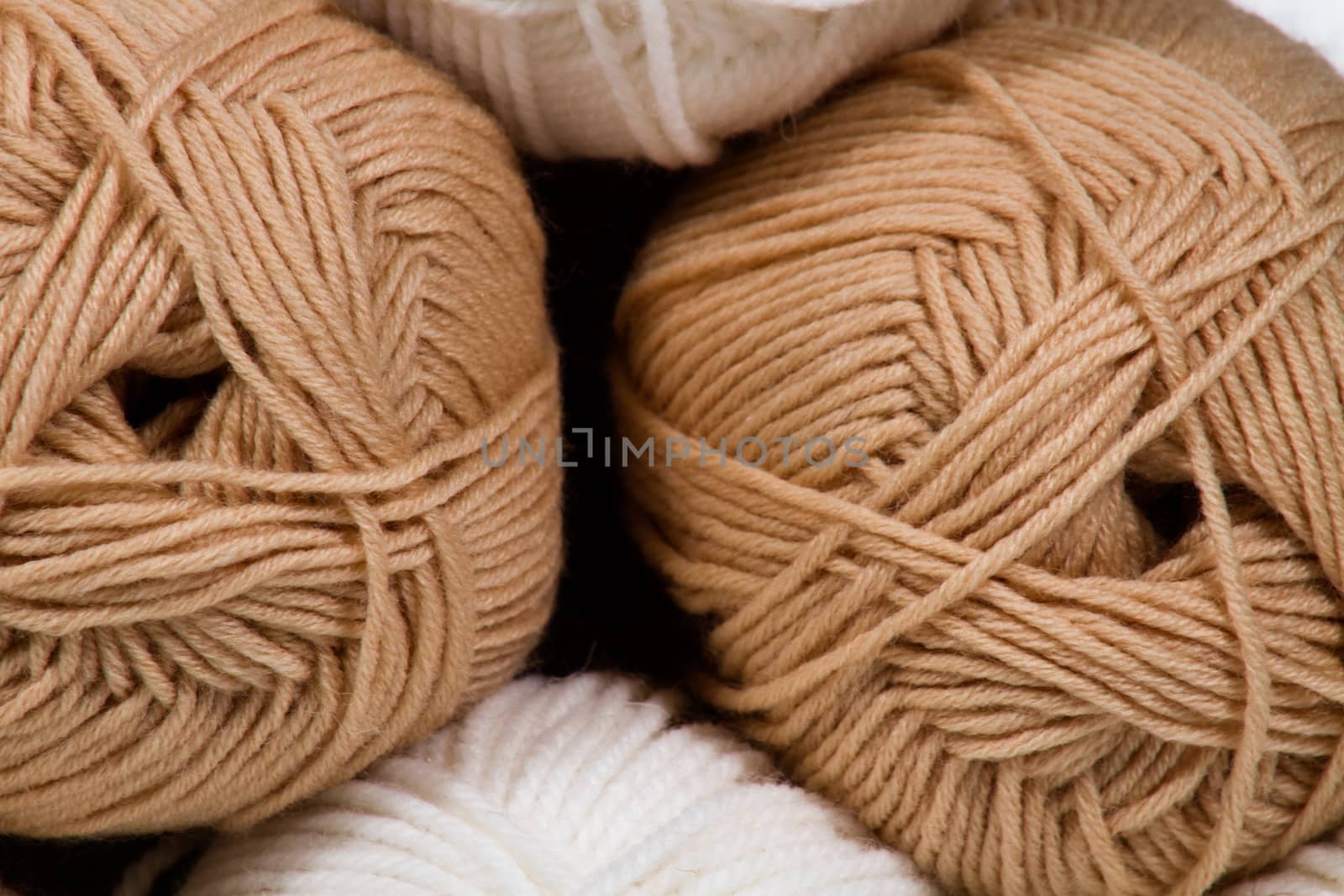 Balls of white and beige wool large abstract background, image craft