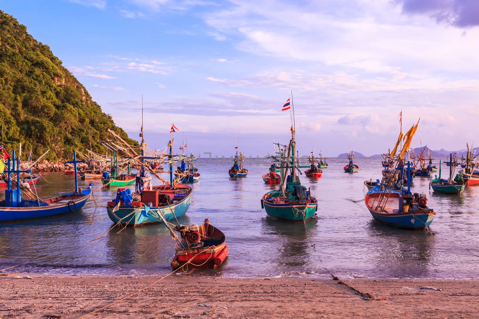 group of fishing boat anchored at Pranburi beach in Thailand