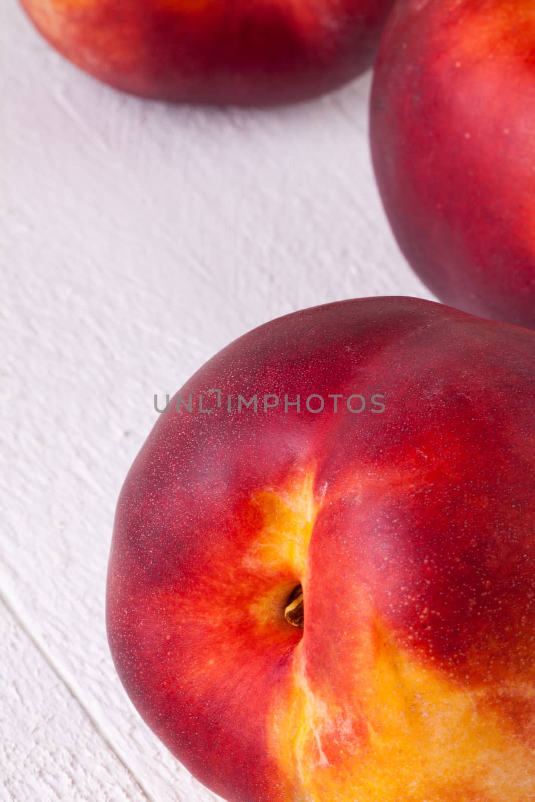 Three tasty fresh ripe juicy nectarines by juniart