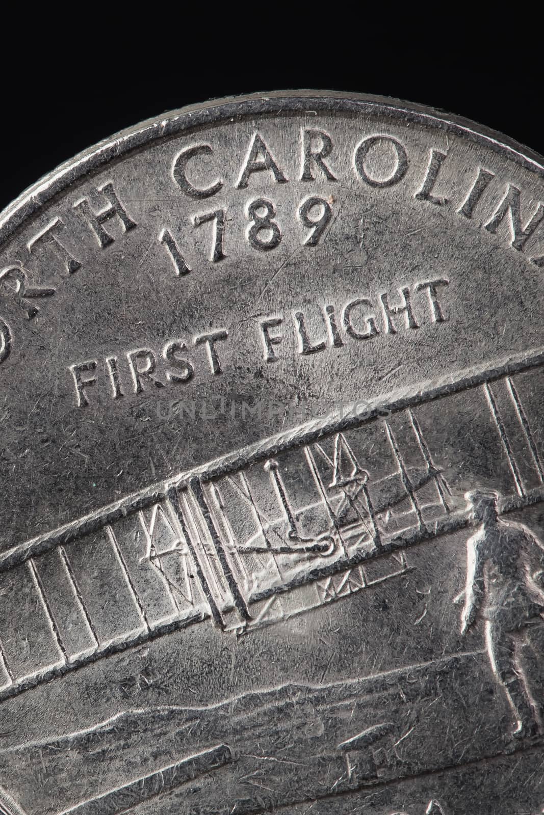 US American coin with wording "First Flight" on black background by FrameAngel
