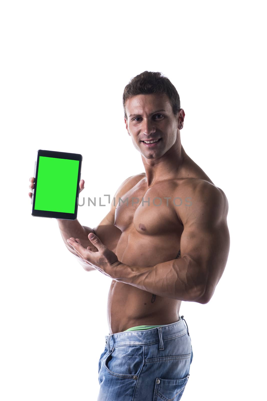 Shirtless young male bodybuiler holding ebook reader or tablet PC by artofphoto