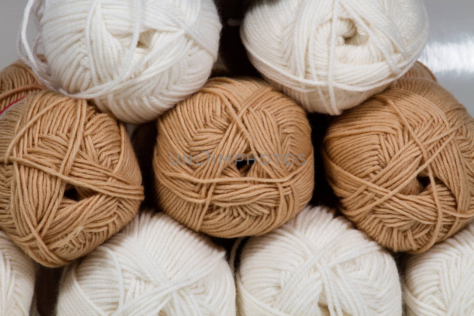 Balls of white and beige wool large abstract background, image craft