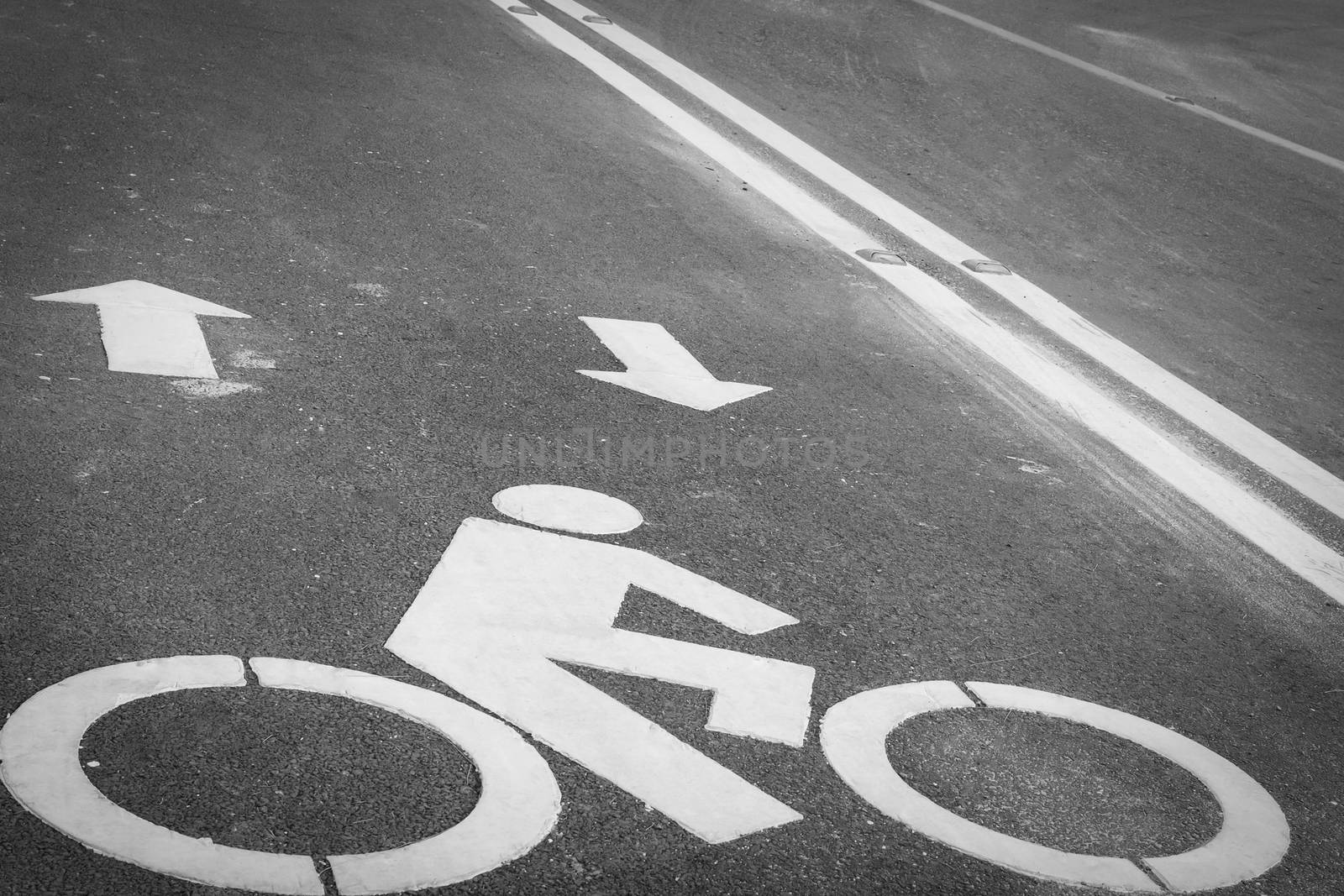 Bicycle lane or path, icon symbol on asphalt road by FrameAngel