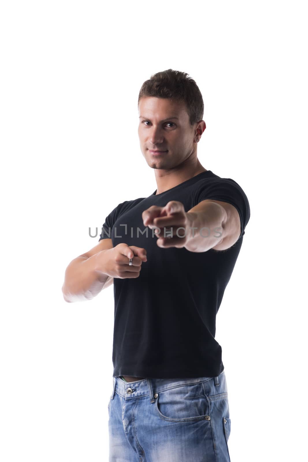 Handsome young man pointing fingers at you, towards the camera, with confident look. Isolated on white