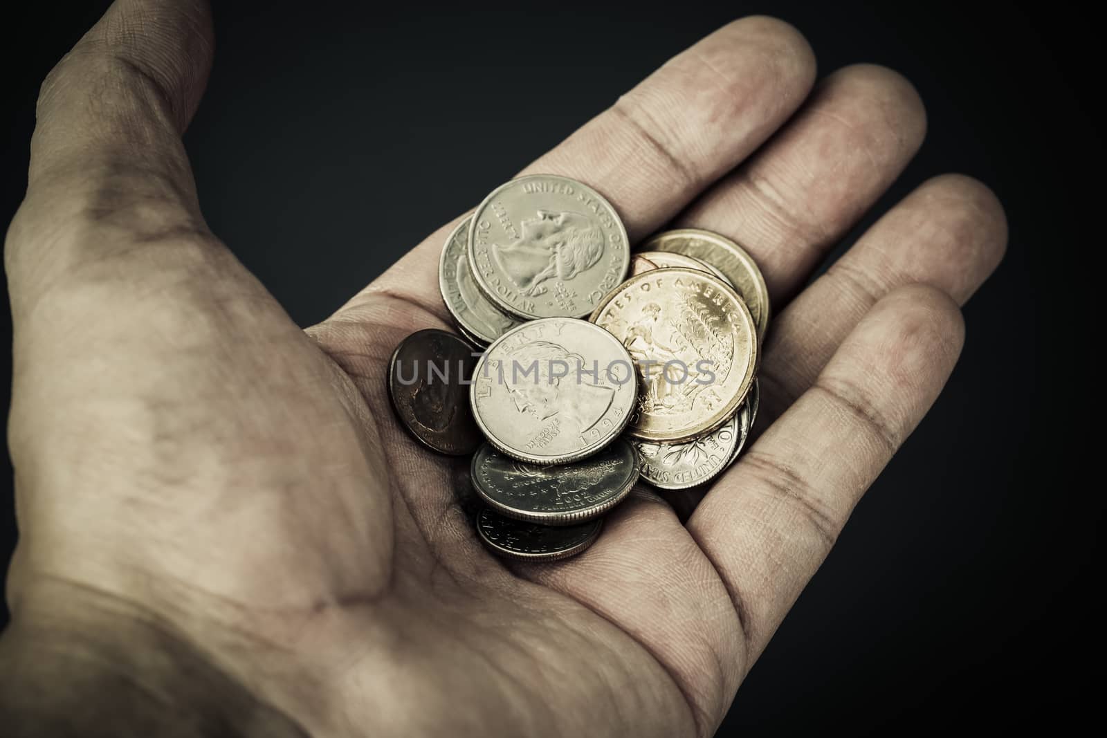 Hand and group of US American coins